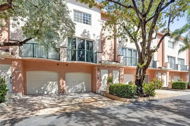 a view of a yard with brick house and a large tree