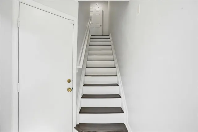 a view of entryway with stairs and white walls