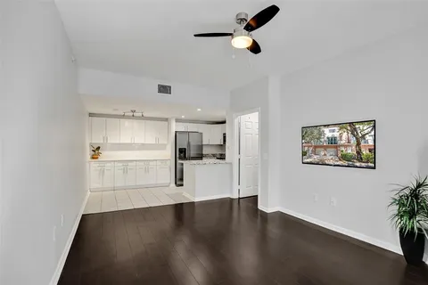 a view of empty room with wooden floor and window
