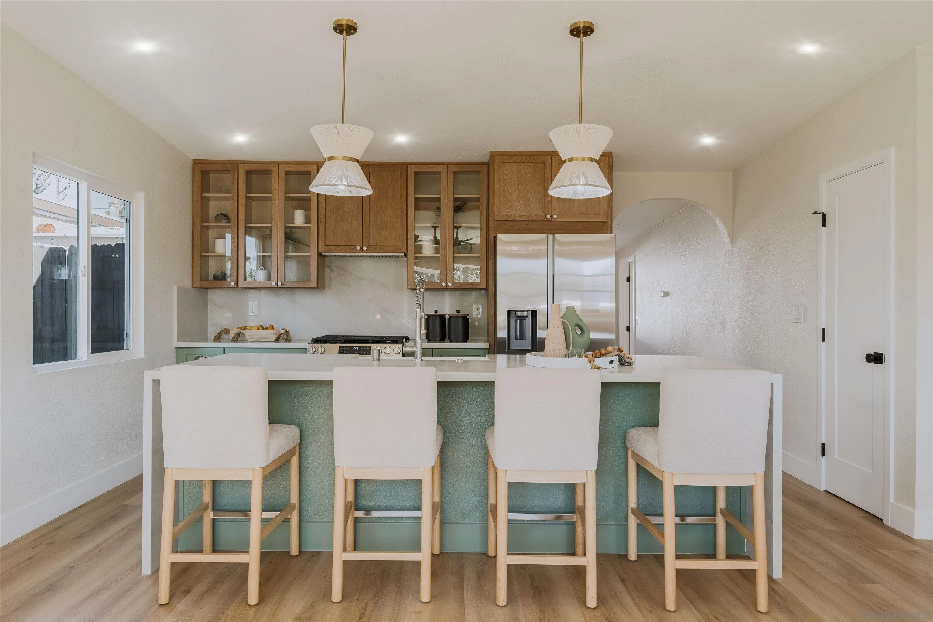 1426 Santa Rosa Street Oceanside, CA 92058 - Photo 16 of 73 a dining room with wooden floor a chandelier a wooden table and chairs