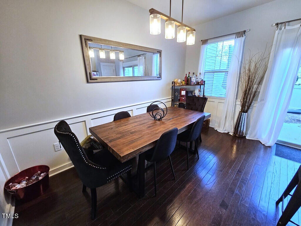7904 Allscott Way Raleigh, NC 27612 - Photo 8 of 32 a dining room with furniture and wooden floor