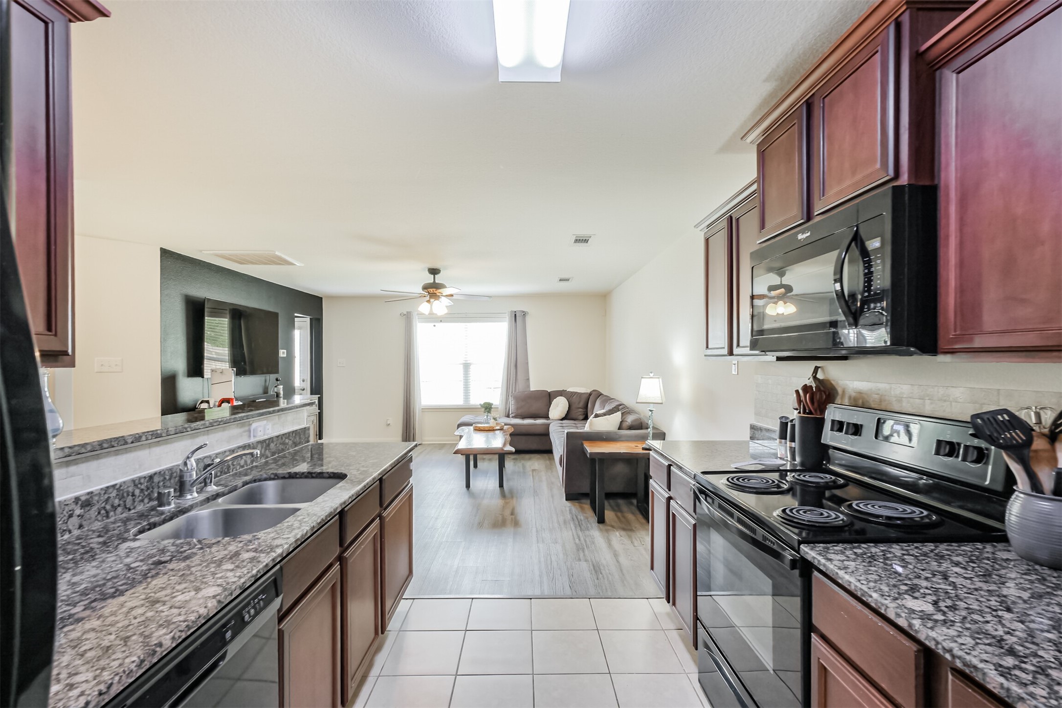 9438 Gold Mountain Drive Rosharon, TX 77583 - Photo 7 of 25 a kitchen with a stove a sink and a refrigerator