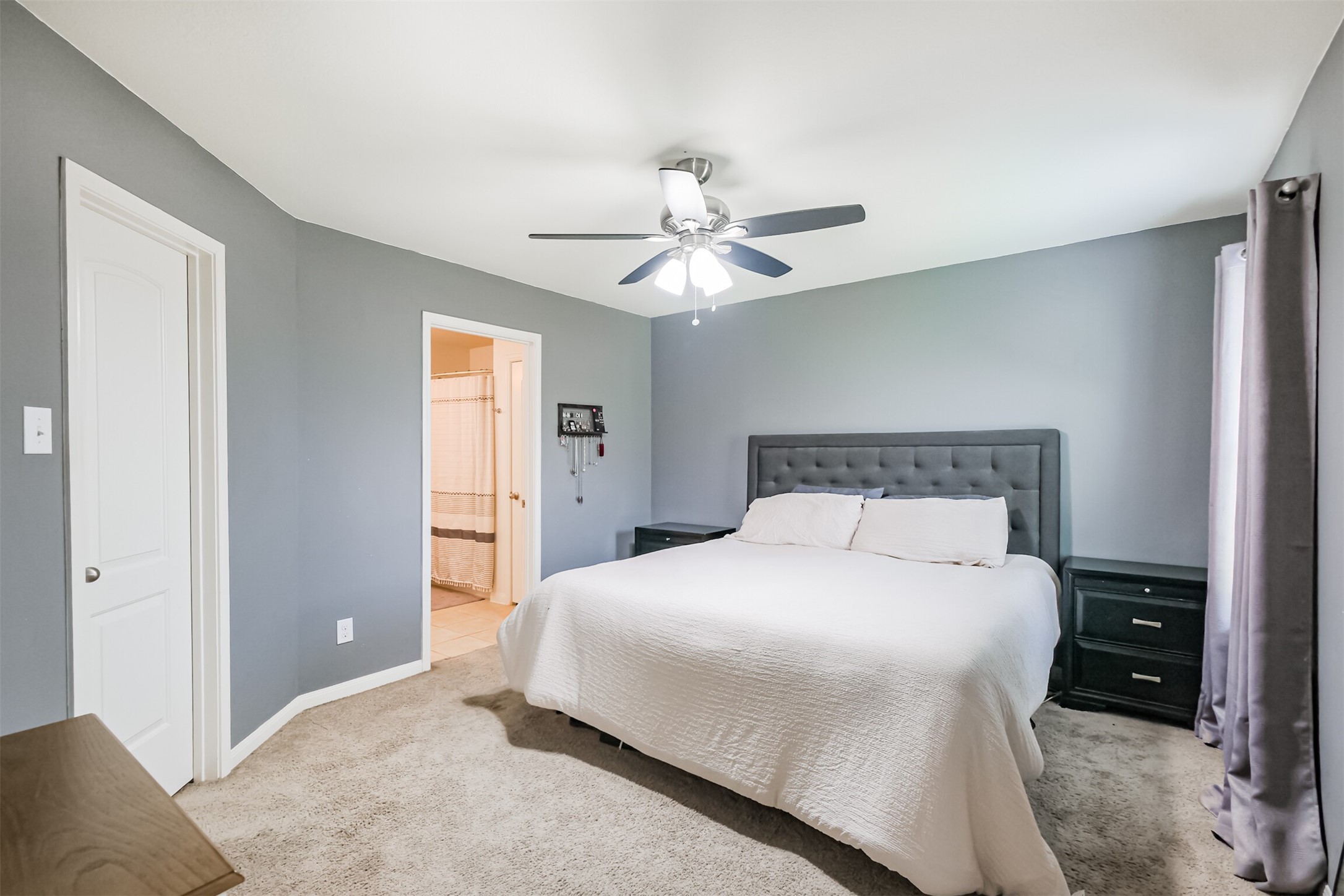 9438 Gold Mountain Drive Rosharon, TX 77583 - Photo 8 of 25 a bedroom with a bed and a chandelier