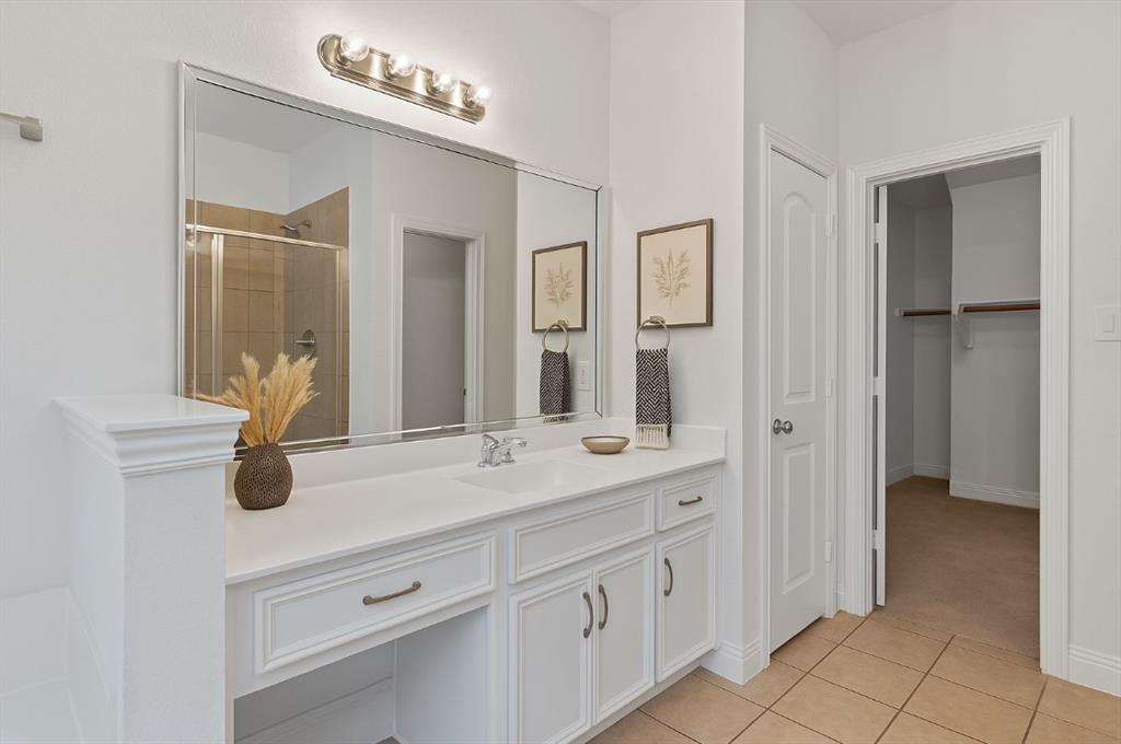 2610 Meadow Ridge Drive Prosper, TX 75078 - Photo 19 of 32 a bathroom with a sink and a mirror