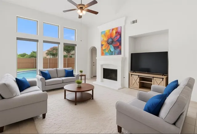 a living room with furniture a flat screen tv and a fireplace