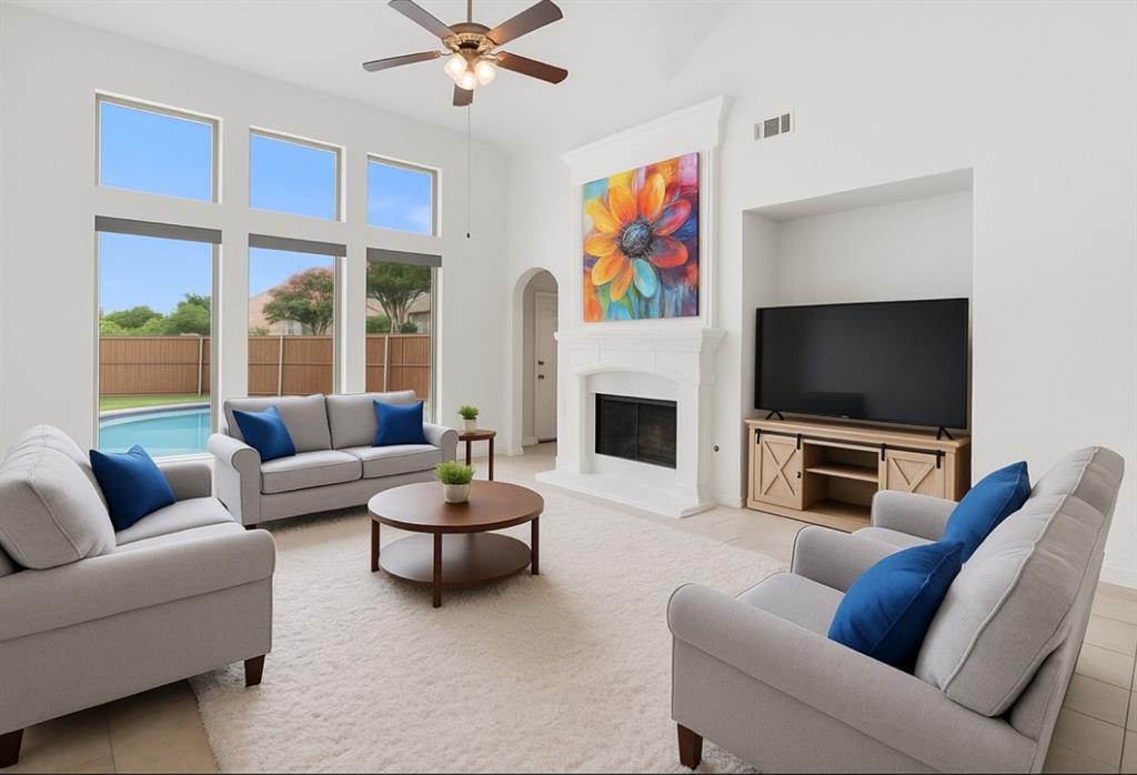2610 Meadow Ridge Drive Prosper, TX 75078 - Photo 2 of 32 a living room with furniture a flat screen tv and a fireplace