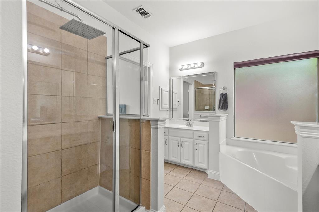 2610 Meadow Ridge Drive Prosper, TX 75078 - Photo 21 of 32 a bathroom with a granite countertop sink mirror and a bathtub