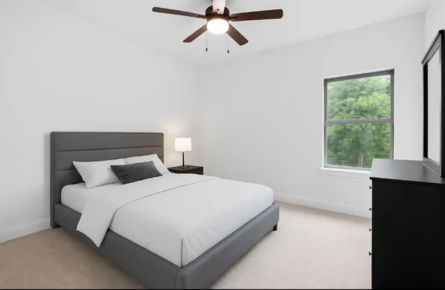 a bedroom with a bed and window