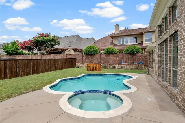 a view of swimming pool with outdoor seating and plants
