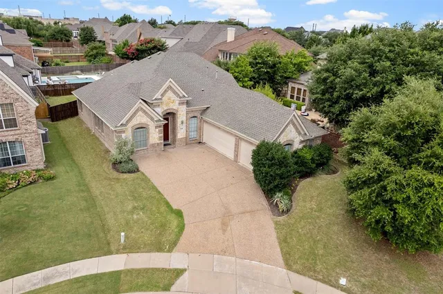 an aerial view of a house with a yard