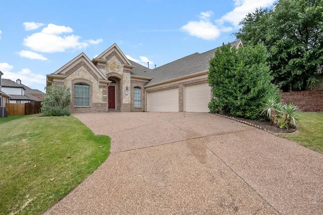 a view of a house with a yard and potted plants