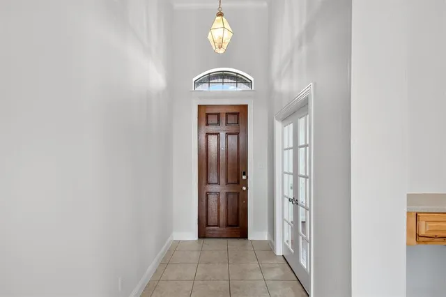 a view of a hallway with wooden door
