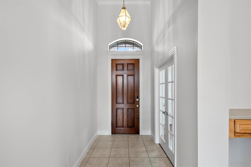 2610 Meadow Ridge Drive Prosper, TX 75078 - Photo 8 of 32 a view of a hallway with wooden door