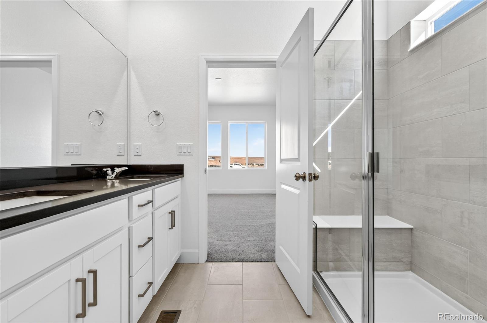 17095 West 92nd Loop Arvada, CO 80007 - Photo 16 of 37 a bathroom with a sink and a mirror