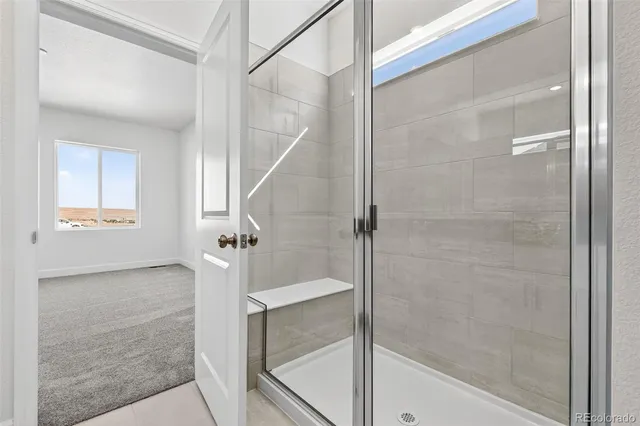 a bathroom with a shower and a mirror