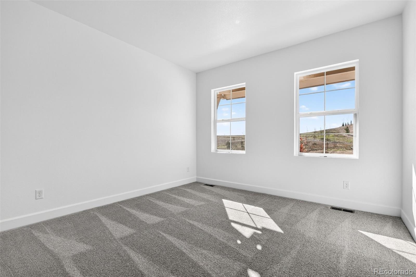 17095 West 92nd Loop Arvada, CO 80007 - Photo 19 of 37 an empty room with windows