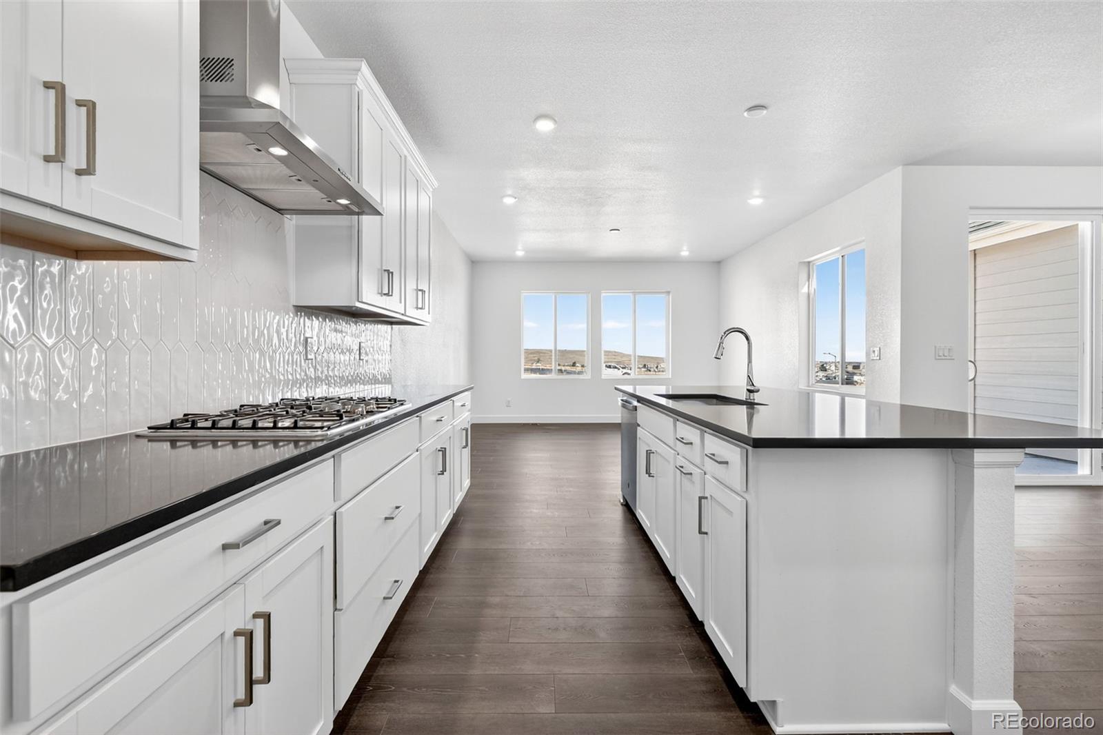 17095 West 92nd Loop Arvada, CO 80007 - Photo 3 of 37 a large kitchen with stainless steel appliances lots of counter space and a sink
