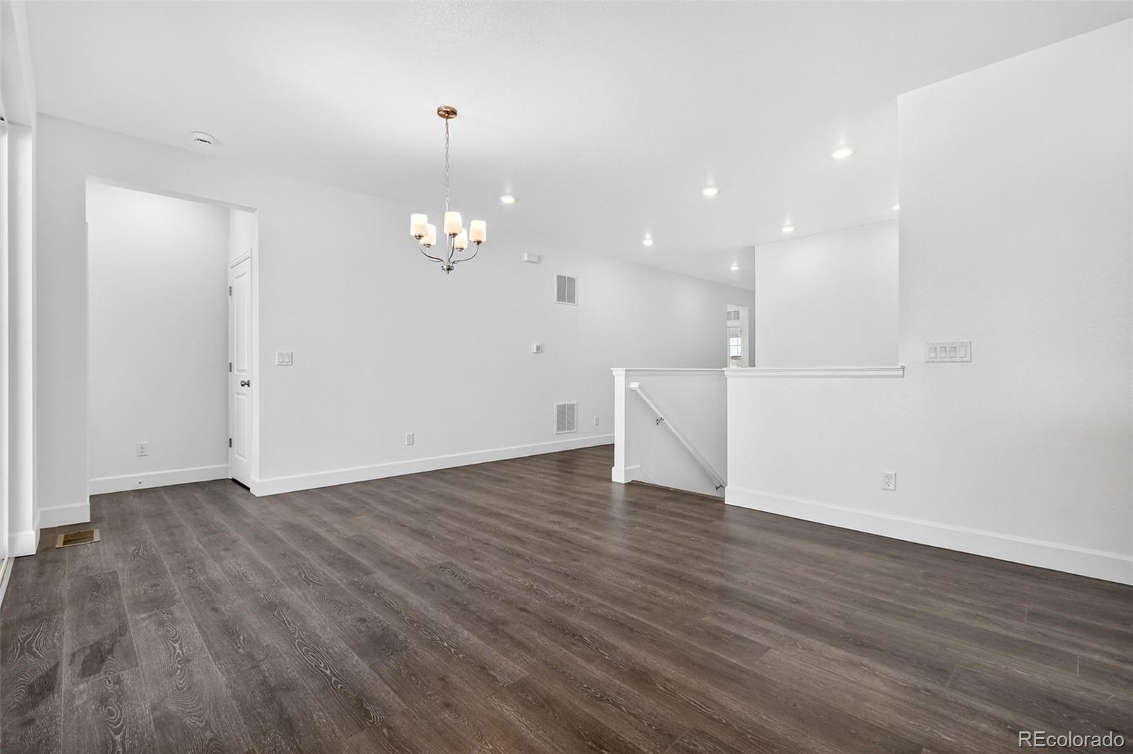 17095 West 92nd Loop Arvada, CO 80007 - Photo 6 of 37 a view of a room with wooden floor and chandelier