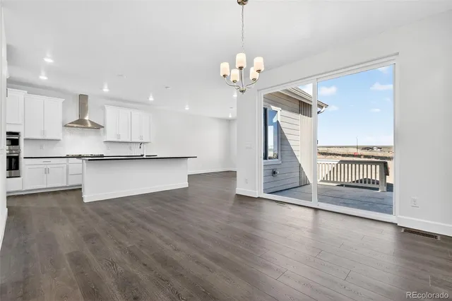 a view of a kitchen with wooden floor and a kitchen