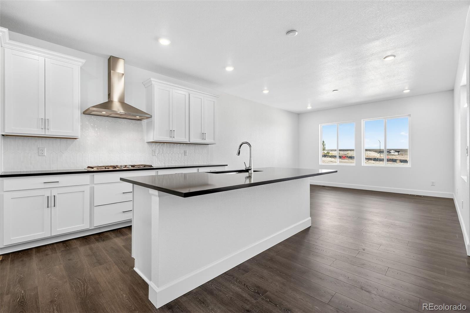 17095 West 92nd Loop Arvada, CO 80007 - Photo 10 of 37 a kitchen with stainless steel appliances granite countertop a sink stove and refrigerator