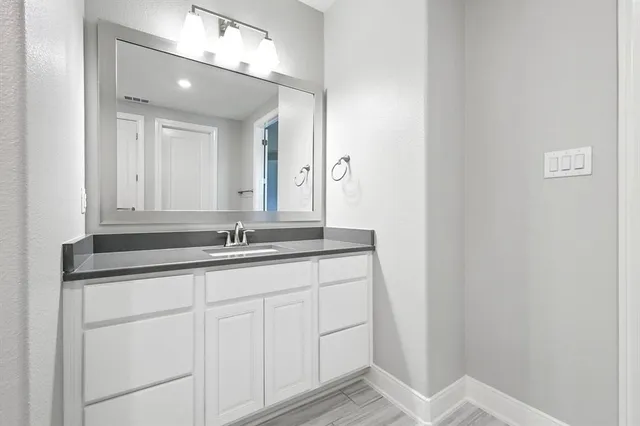 a bathroom with a sink double vanity and a mirror