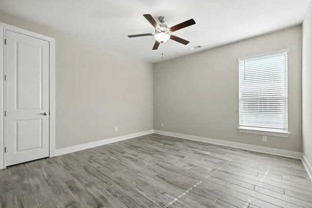 a bathroom with a granite countertop sink mirror vanity and toilet