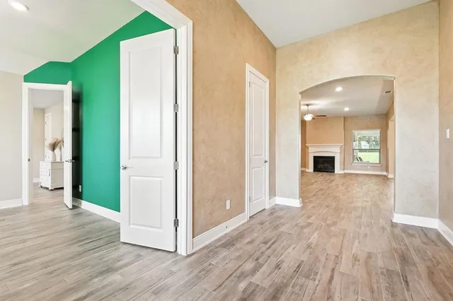 a view of a hallway with wooden floor