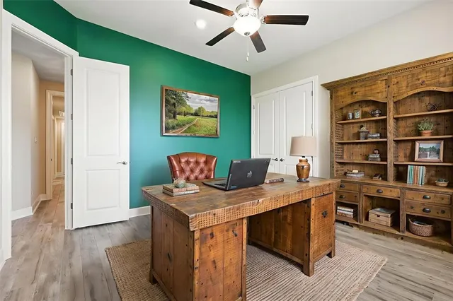 a view of a workspace with furniture and wooden floor