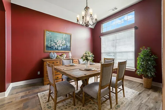 a view of a dining room with furniture and chandelier