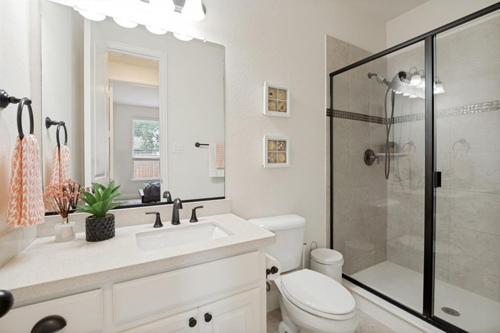 14215 Raspberry Lane Frisco, TX 75035 - Photo 14 of 30 Bathroom featuring a vanity with an integrated sink, light-toned countertop, and white cabinetry with dark hardware
