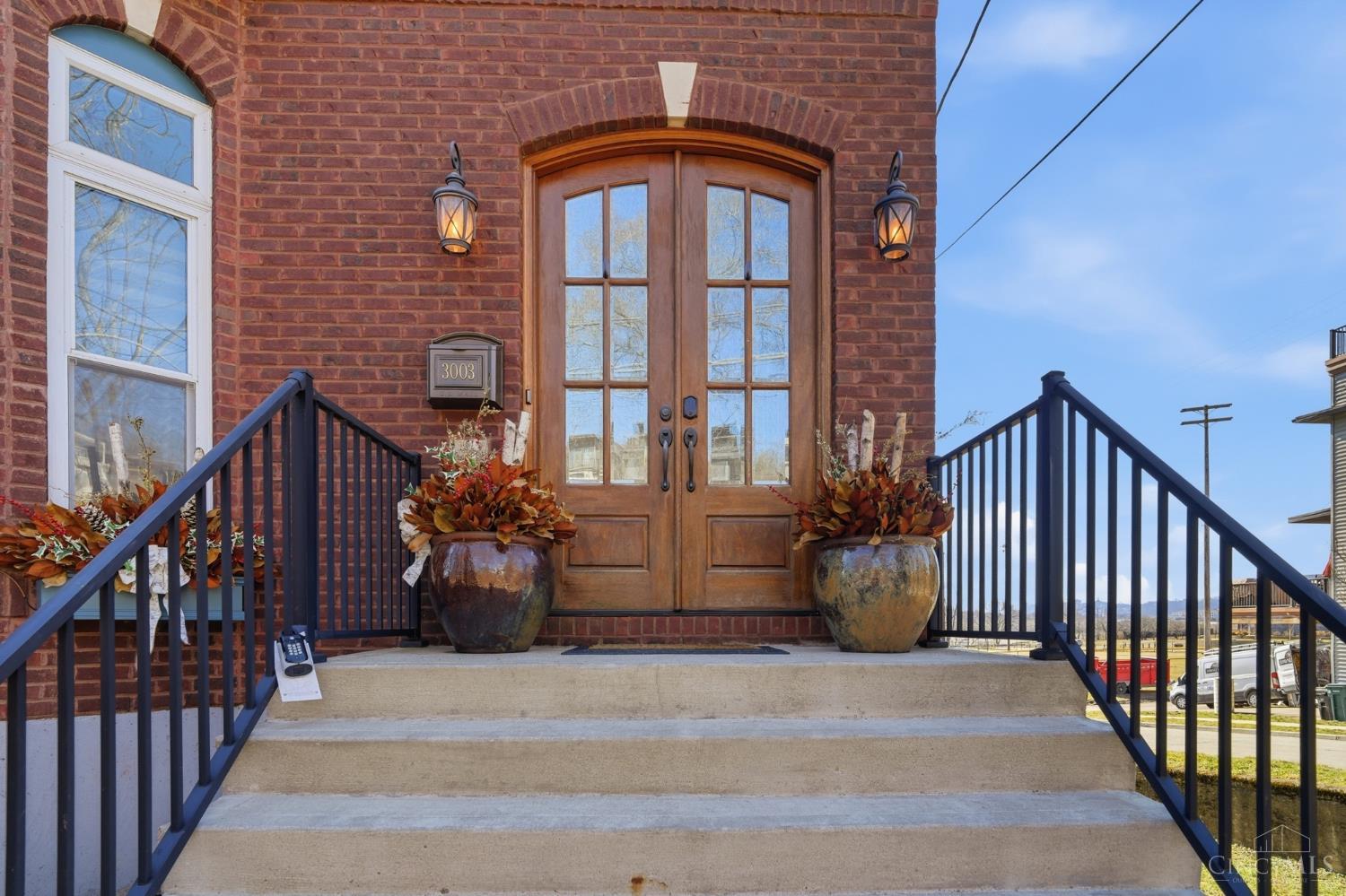 3003 Riverside Drive Cincinnati, OH 45226 - Photo 2 of 65 Nestled into the East End community, this three-story brick beauty delivers charm, character, and comfort at every turn. Large windows frame the water like artwork and flood the space with sunlight. Two balconies invite you to slow down and stay awhile. And inside?