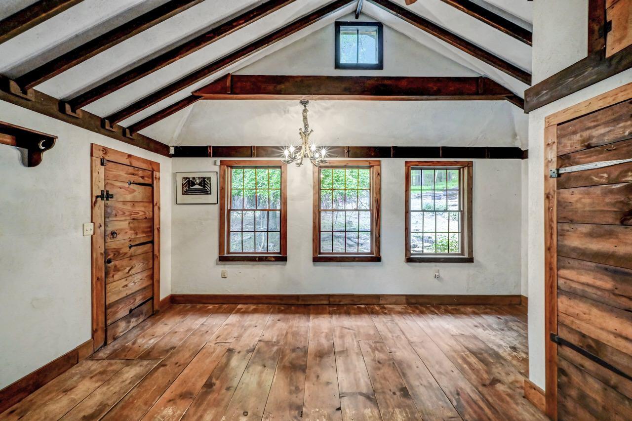 2285 Bear Town Road Canadensis, PA 18325 - Photo 24 of 58 an empty room with wooden floor and windows
