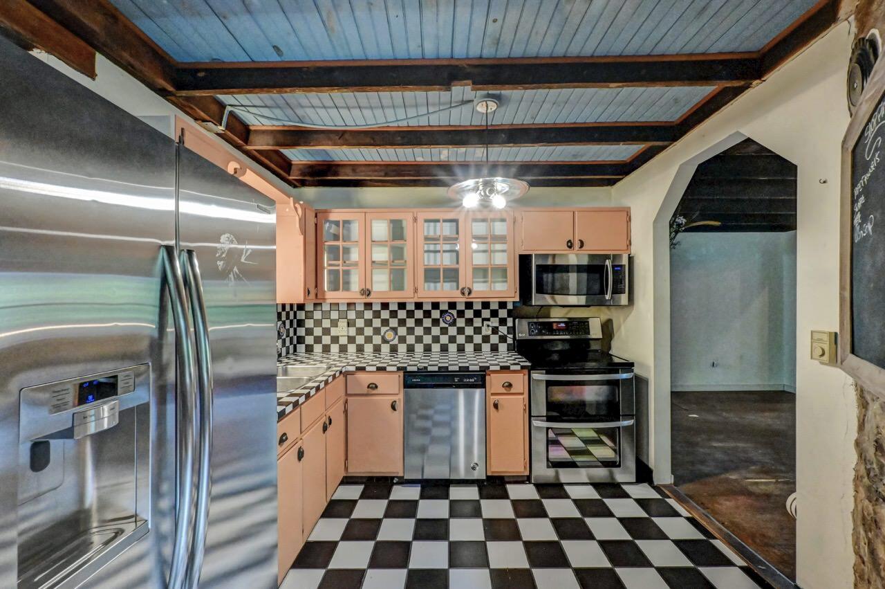 2285 Bear Town Road Canadensis, PA 18325 - Photo 26 of 58 a kitchen with granite countertop a refrigerator and a stove