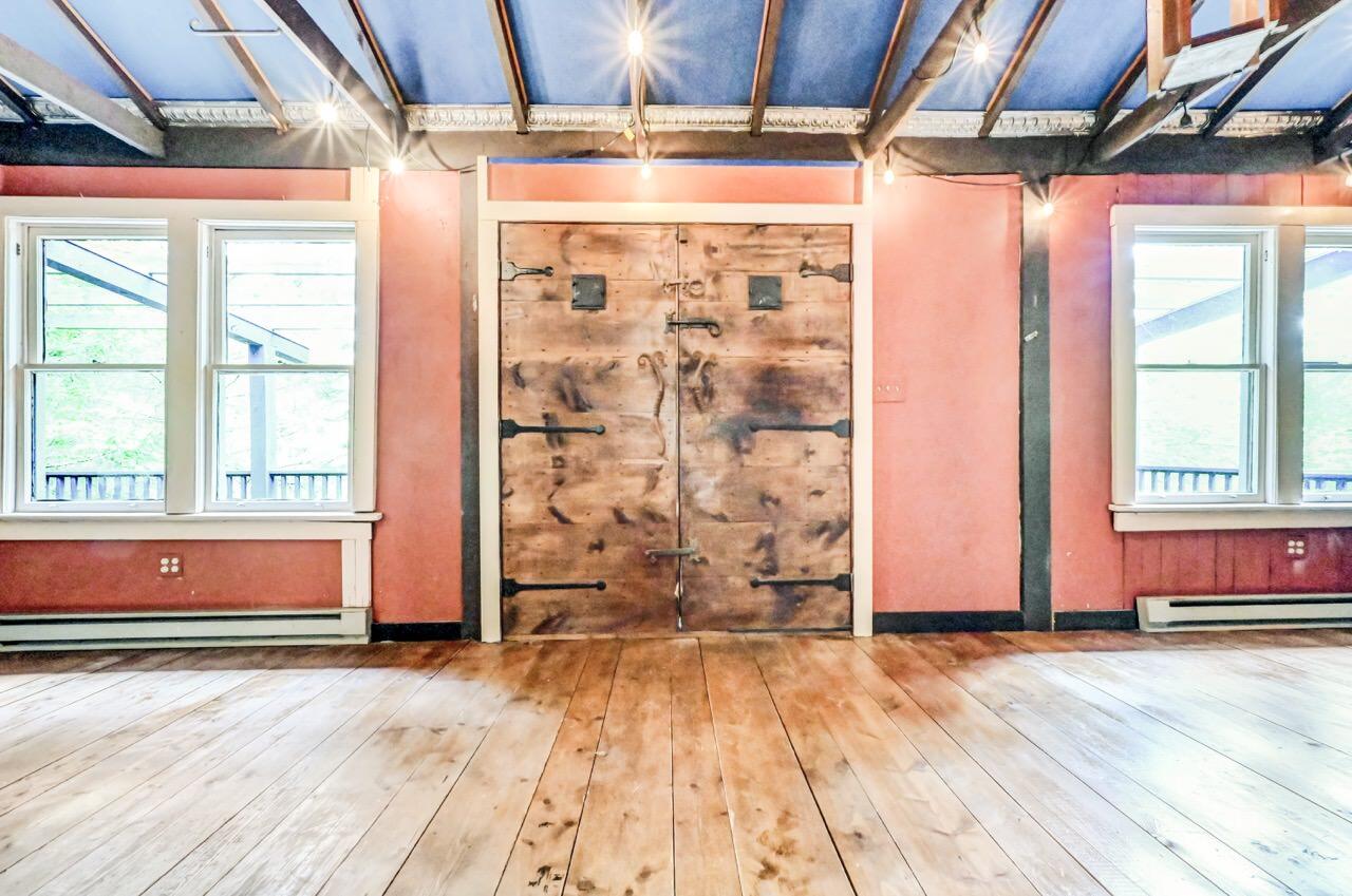 2285 Bear Town Road Canadensis, PA 18325 - Photo 10 of 58 an empty room with wooden floor and windows