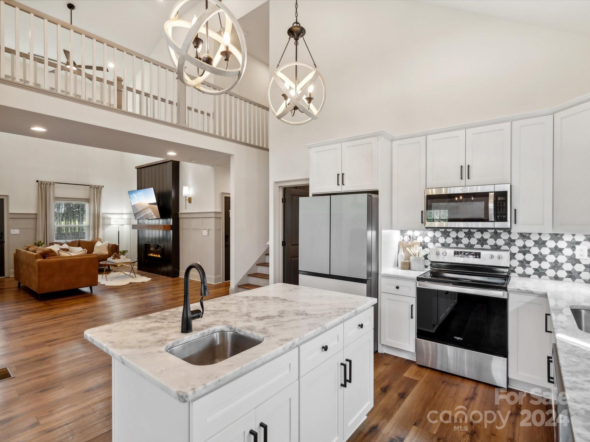 246 East Rambo Road Rock Hill, SC 29730 - Photo 15 of 48 a kitchen with kitchen island granite countertop a sink stainless steel appliances a dining table and chairs