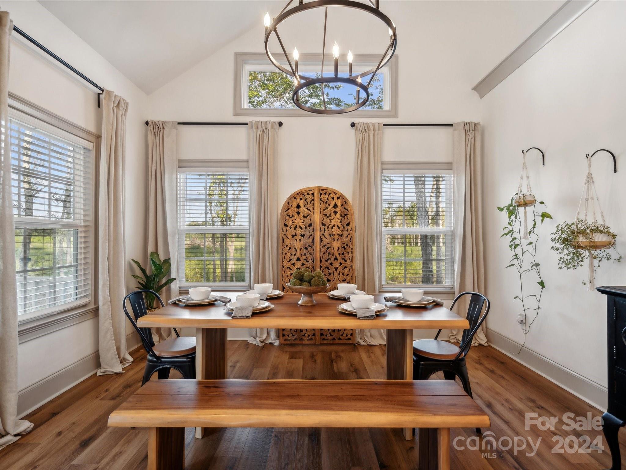 246 East Rambo Road Rock Hill, SC 29730 - Photo 17 of 48 a dining room with wooden floor a chandelier a wooden table and chairs