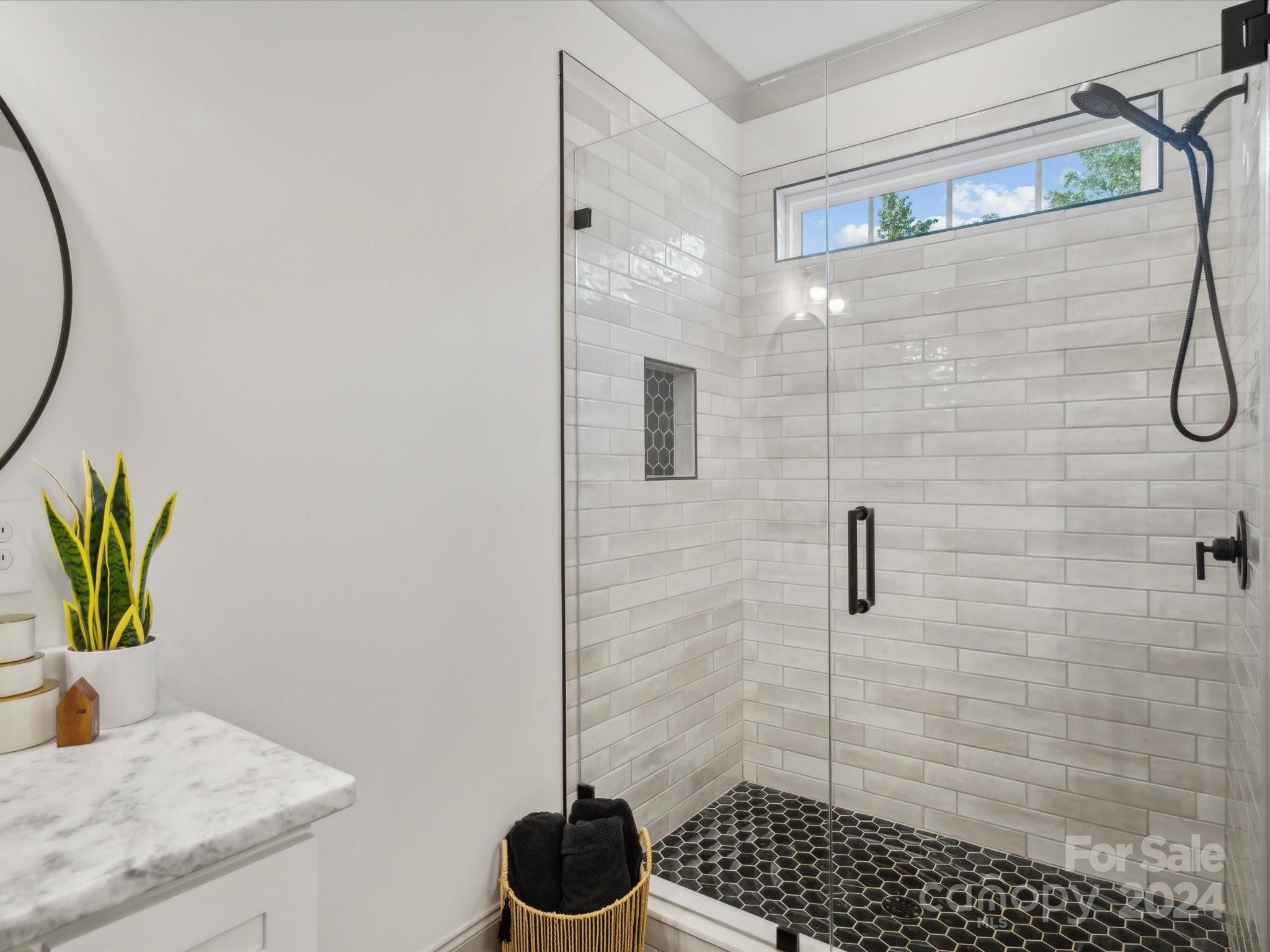 246 East Rambo Road Rock Hill, SC 29730 - Photo 22 of 48 a bathroom with a granite countertop sink a light fixture and a shower