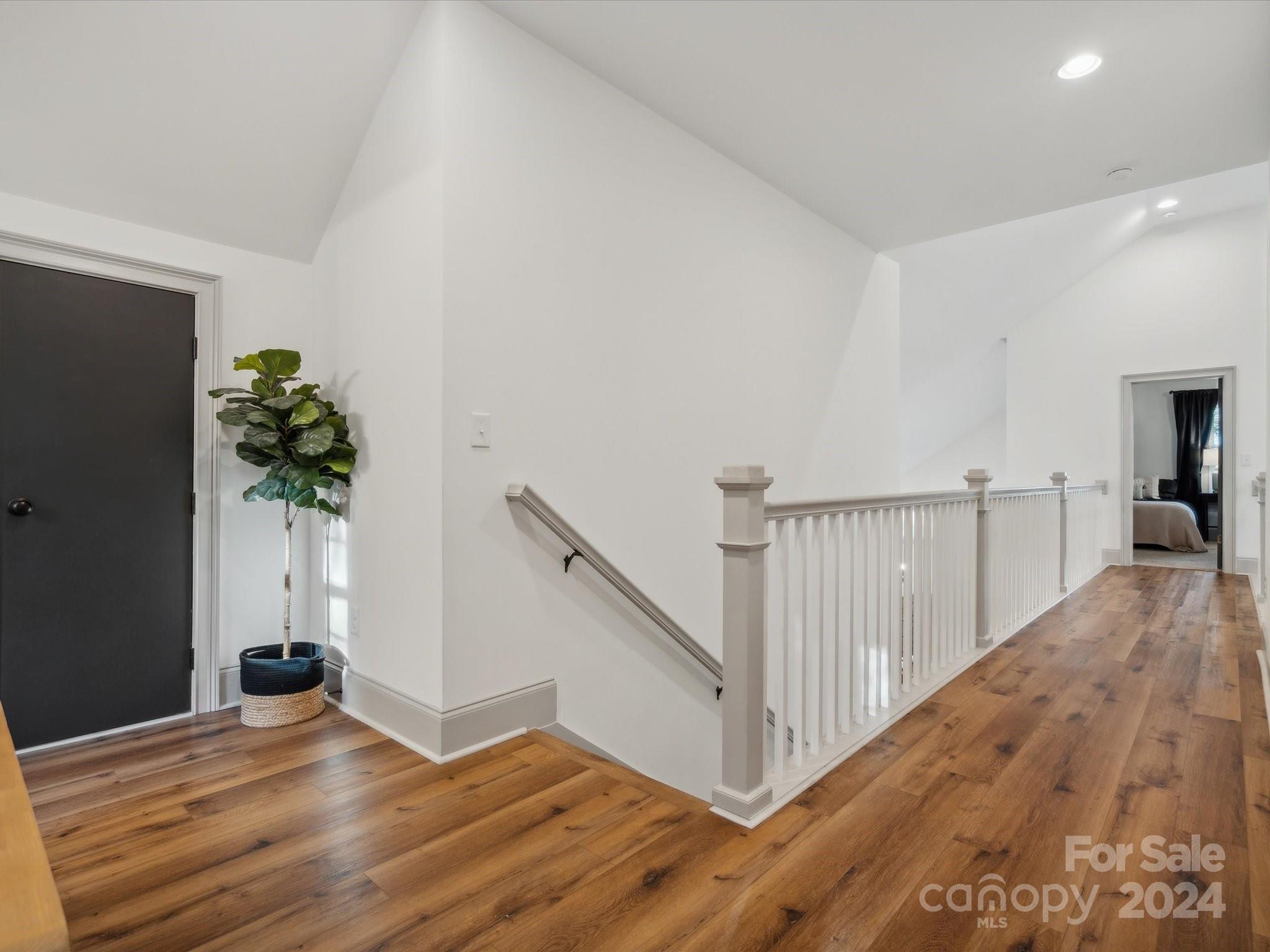 246 East Rambo Road Rock Hill, SC 29730 - Photo 31 of 48 a view of a hallway with wooden floor and a potted plant