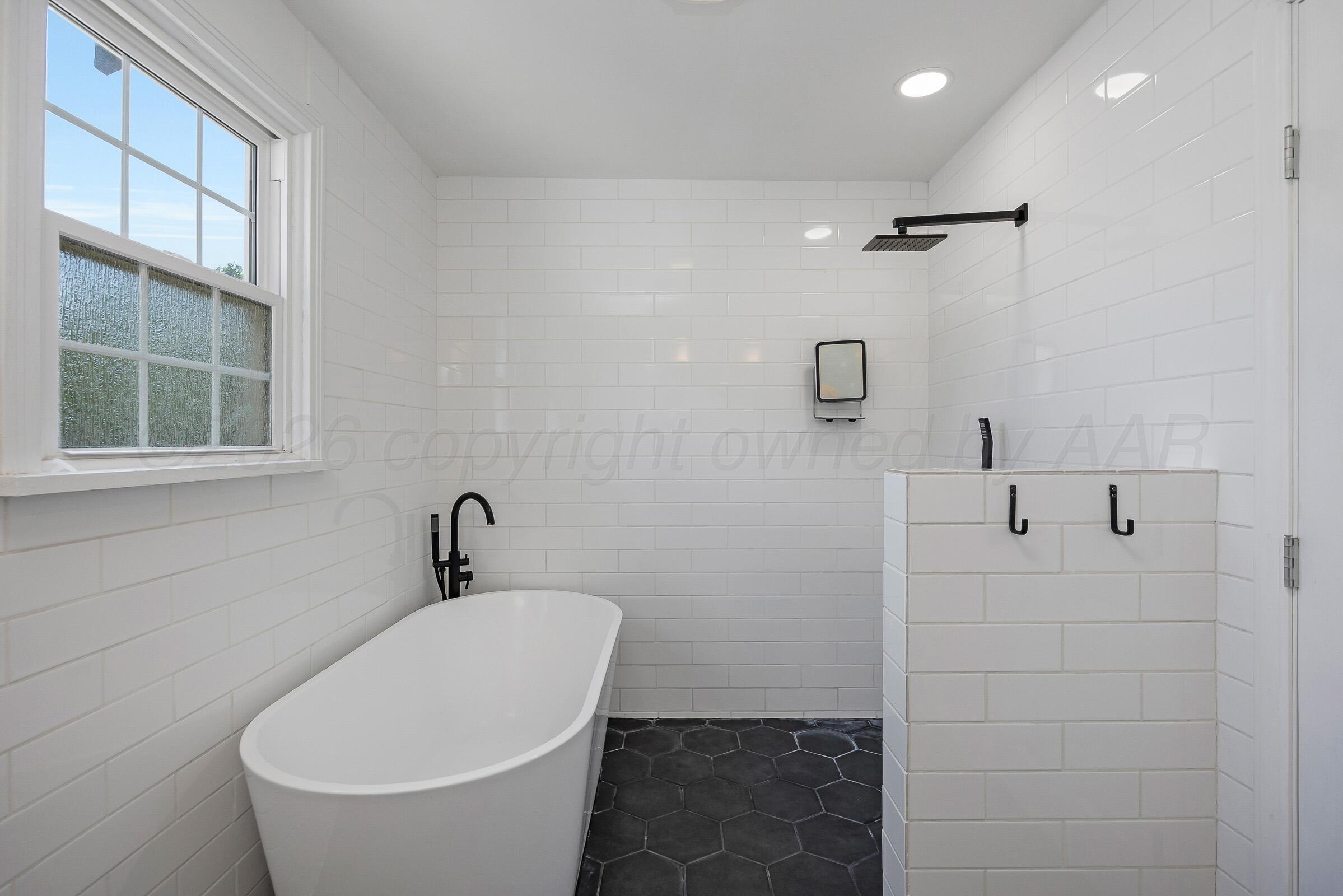 2102 South Hayden Street Amarillo, TX 79109 - Photo 28 of 44 a white bath tub sitting next to a white sink