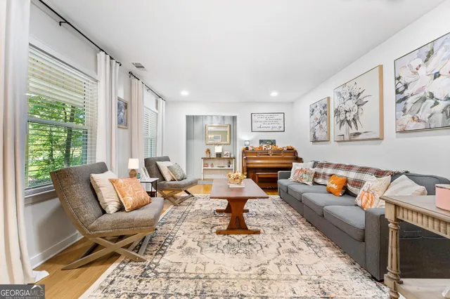 a living room with furniture a rug and a large window
