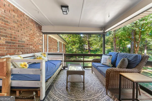 a view of a patio with couches chairs and potted plants