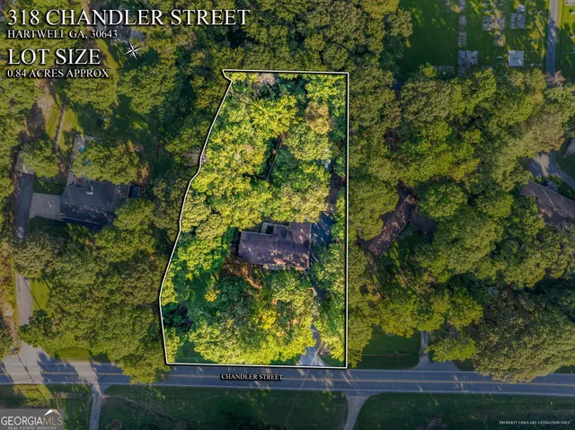 an aerial view of residential houses with outdoor space and street view