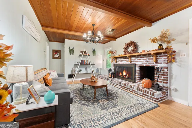 a living room with furniture a fireplace and a table