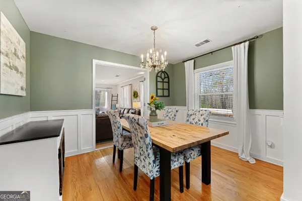a view of a dining room with furniture window and wooden floor