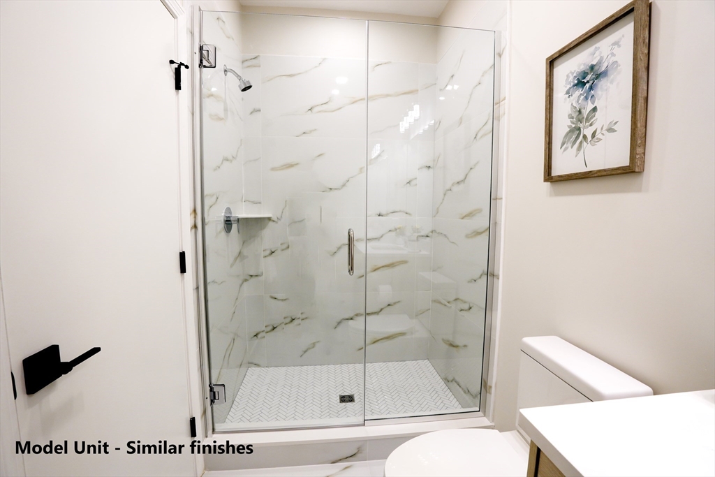 680 Worcester Street, Unit 301 Wellesley, MA 02482 - Photo 8 of 13 a bathroom with a bathtub and a shower