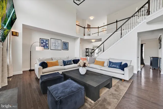 a kitchen with stainless steel appliances granite countertop a stove top oven a sink dishwasher a dining table and chairs with wooden floor