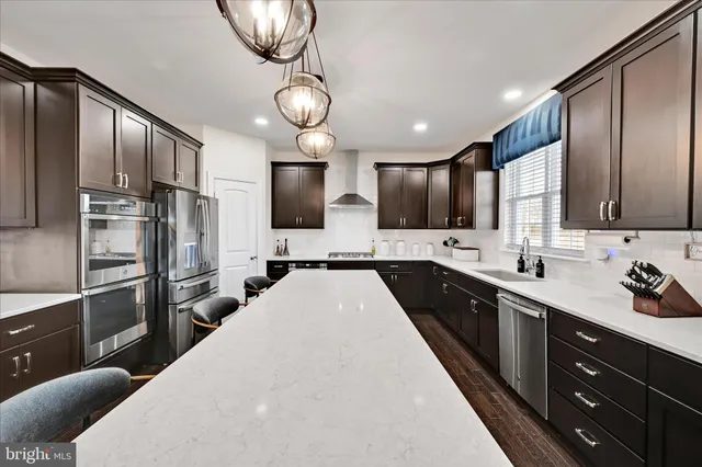 a kitchen with a sink stove and refrigerator