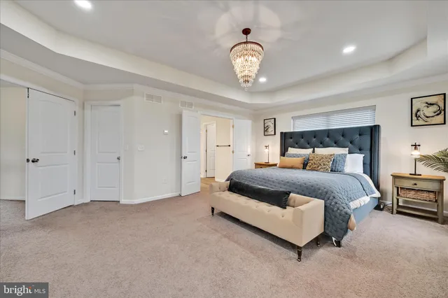 a bedroom with a bed and a chandelier