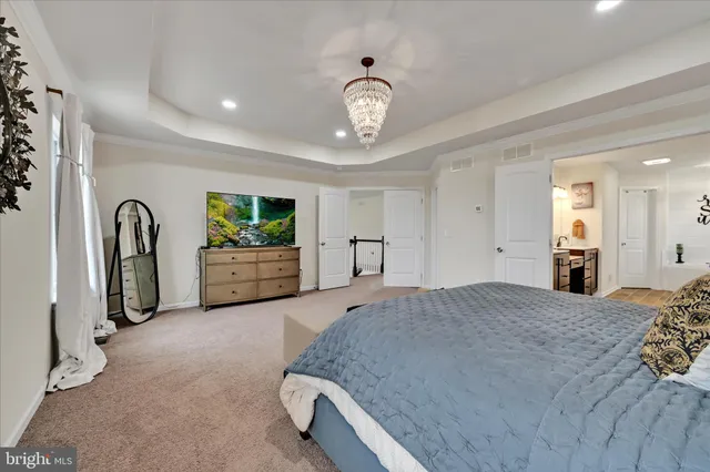 a bedroom with a bed and a chandelier