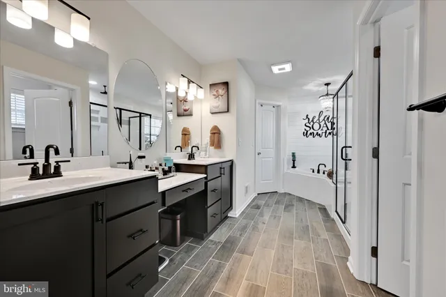 a spacious bedroom with a bed a couch and a flat tv screen